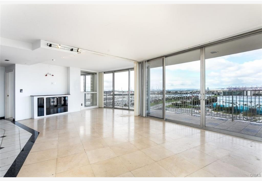 700 E Ocean Blvd #2308 — expanded great room with floor-to-ceiling glass and panoramic ocean views