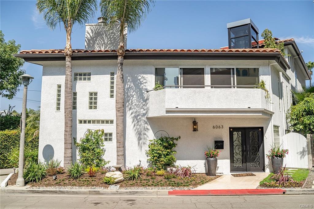 6063 Lido Ln — street elevation of the three-story Mediterranean residence