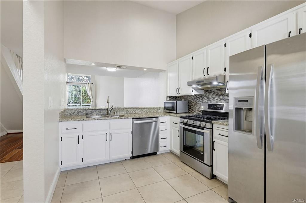 3650 S Bear St #77 — kitchen with stainless steel appliances and granite counters