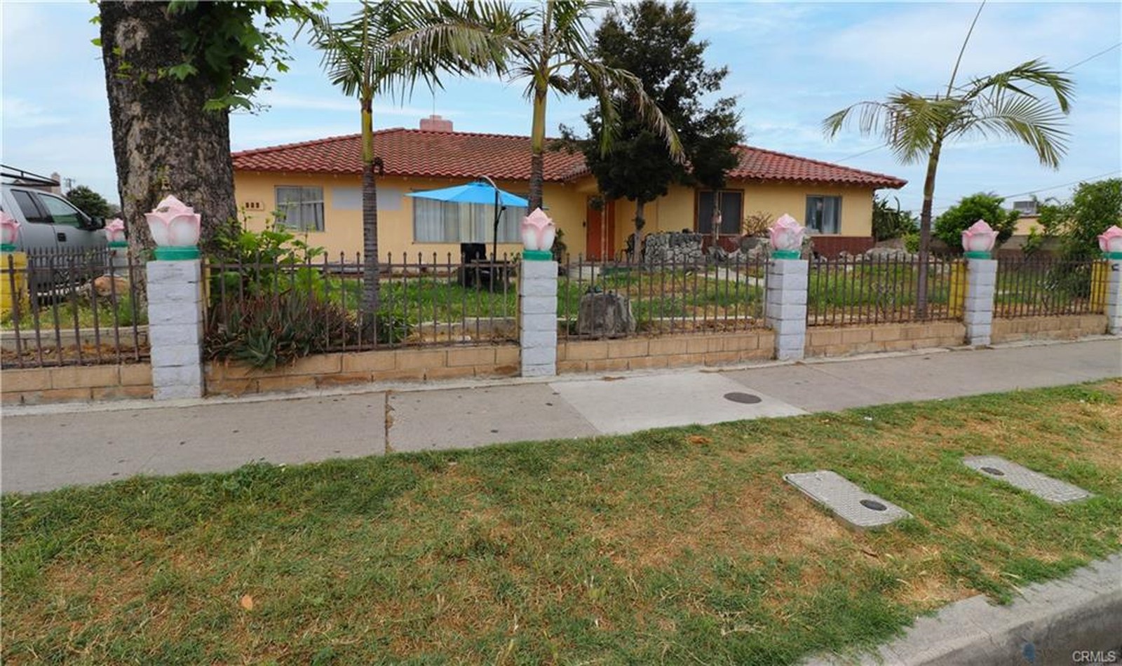 803 S Sullivan St — street frontage of the existing home behind a gated wall