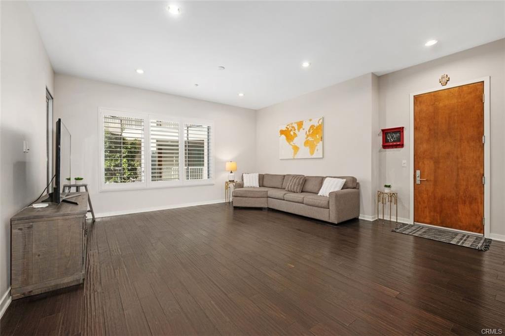 21 Gramercy #202 — open living room with hardwood floors and ten-foot ceilings