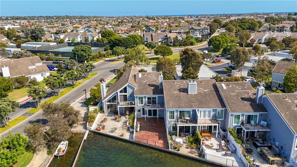 3631 Windspun Dr — aerial of the home's lagoon frontage and private boat dock