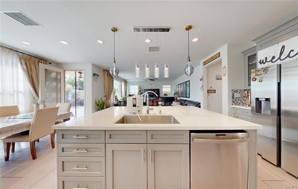 12954 Dahlia St — kitchen island open to the dining and great room