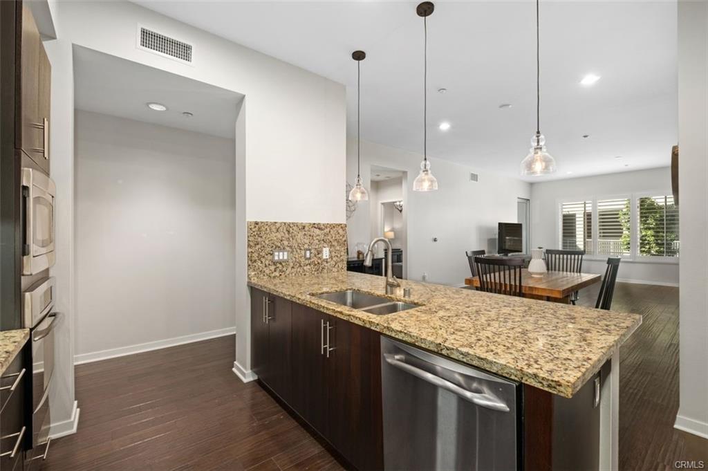 21 Gramercy #202 — kitchen with stainless GE appliances and granite backsplash