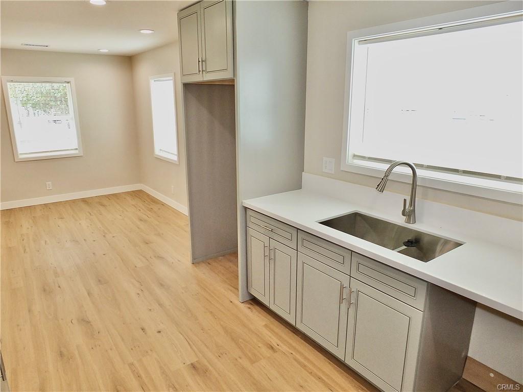 1335 W Burnett St — kitchen sink and counter run with abundant natural light