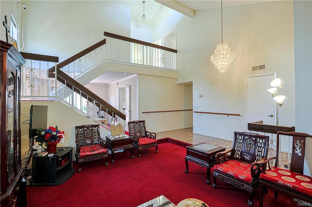 17031 Ward St — two-story entry with staircase and chandelier