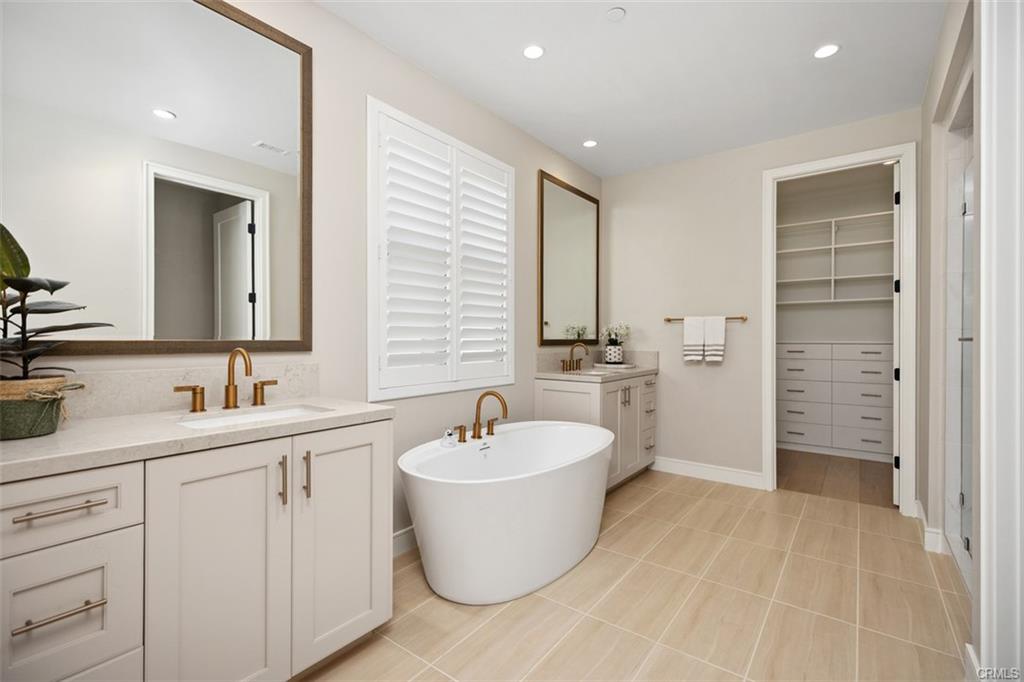 142 Sabbia — primary bath with freestanding soaking tub and dual vanities