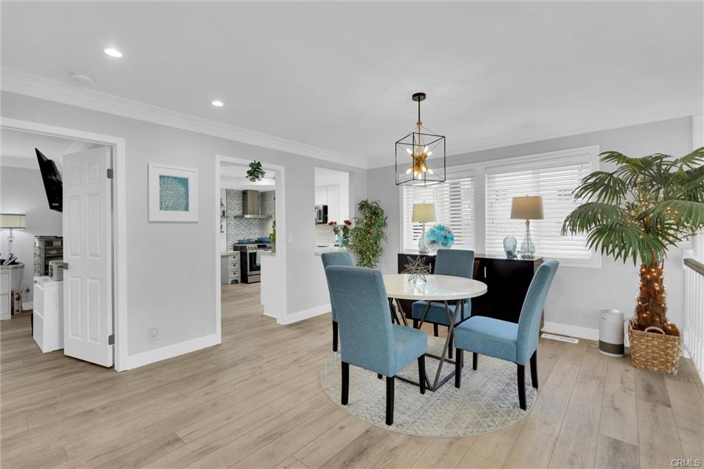 16276 Pacific Cir #B — kitchen with stainless appliances, quartz counters, and breakfast nook