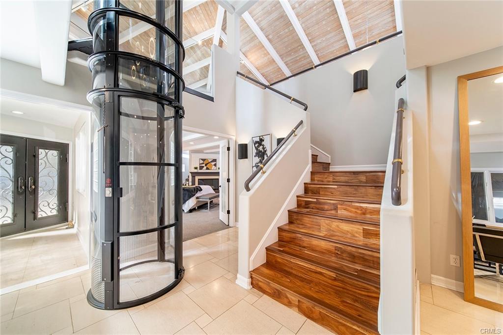 6063 Lido Ln — glass vacuum elevator serving all three levels