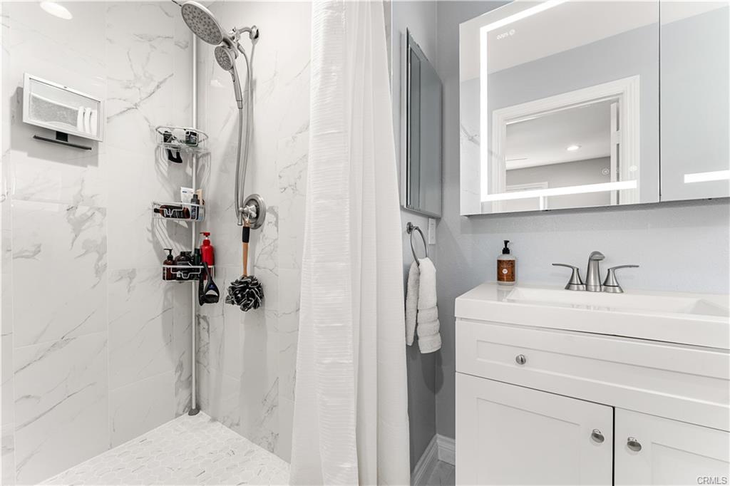 1170 Gleneagles — remodeled primary bath with tiled shower enclosure and modern vanity