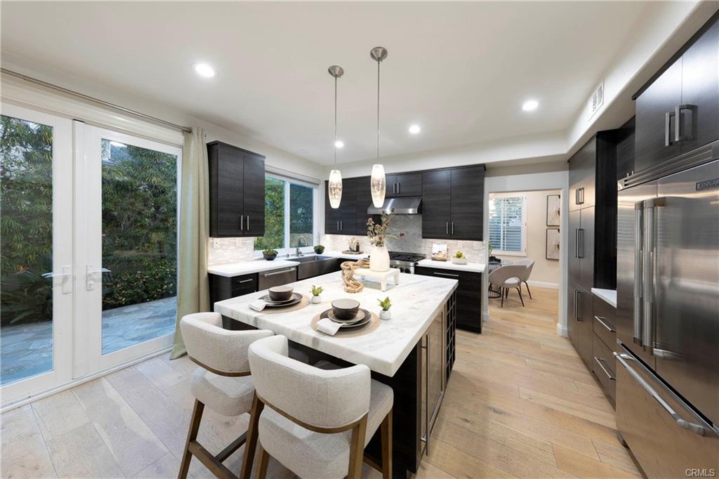 43 Lessay — kitchen island with seating open to the dining area and sliders