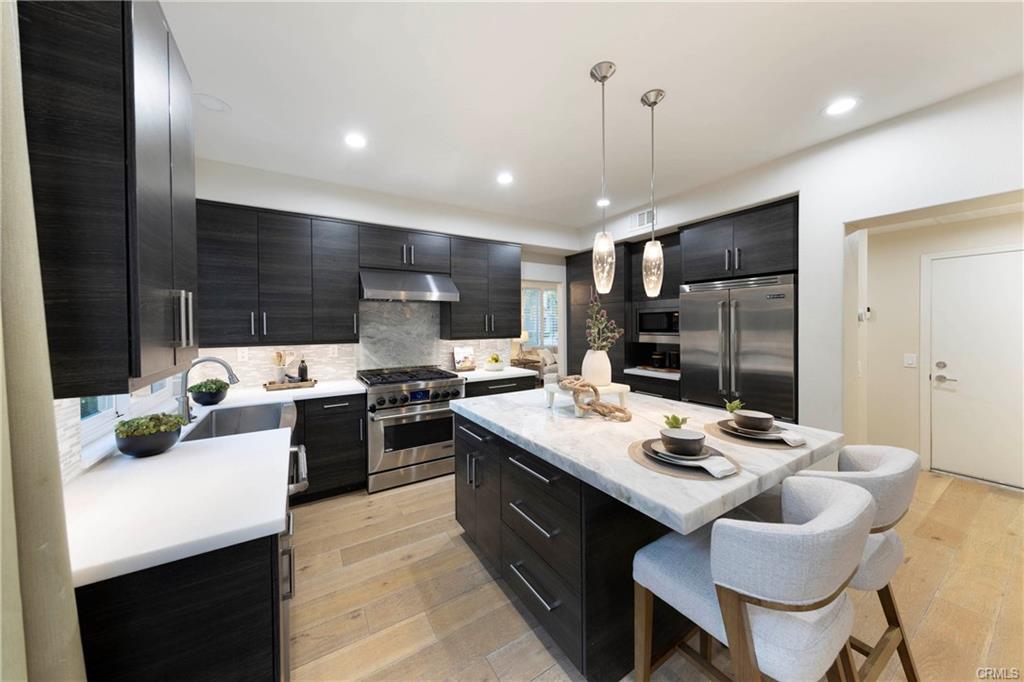 43 Lessay — kitchen detail with stainless steel appliances and pendant lighting