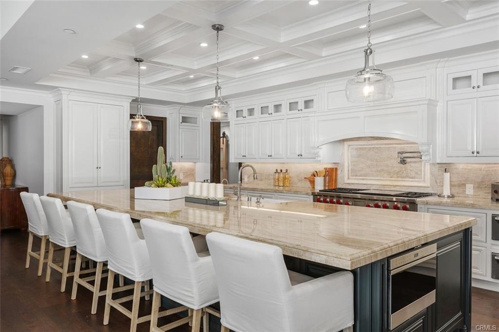 4 Inverness Lane — chef's kitchen with oversized marble island and bar seating