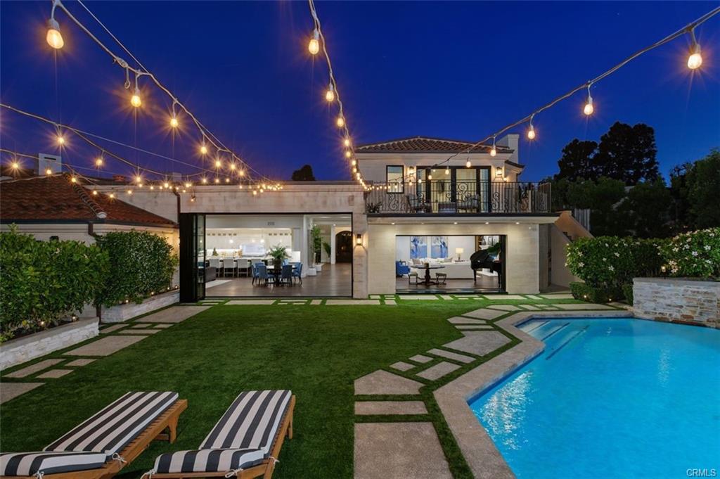4 Inverness Lane — pool, spa, and string-lit grounds at twilight